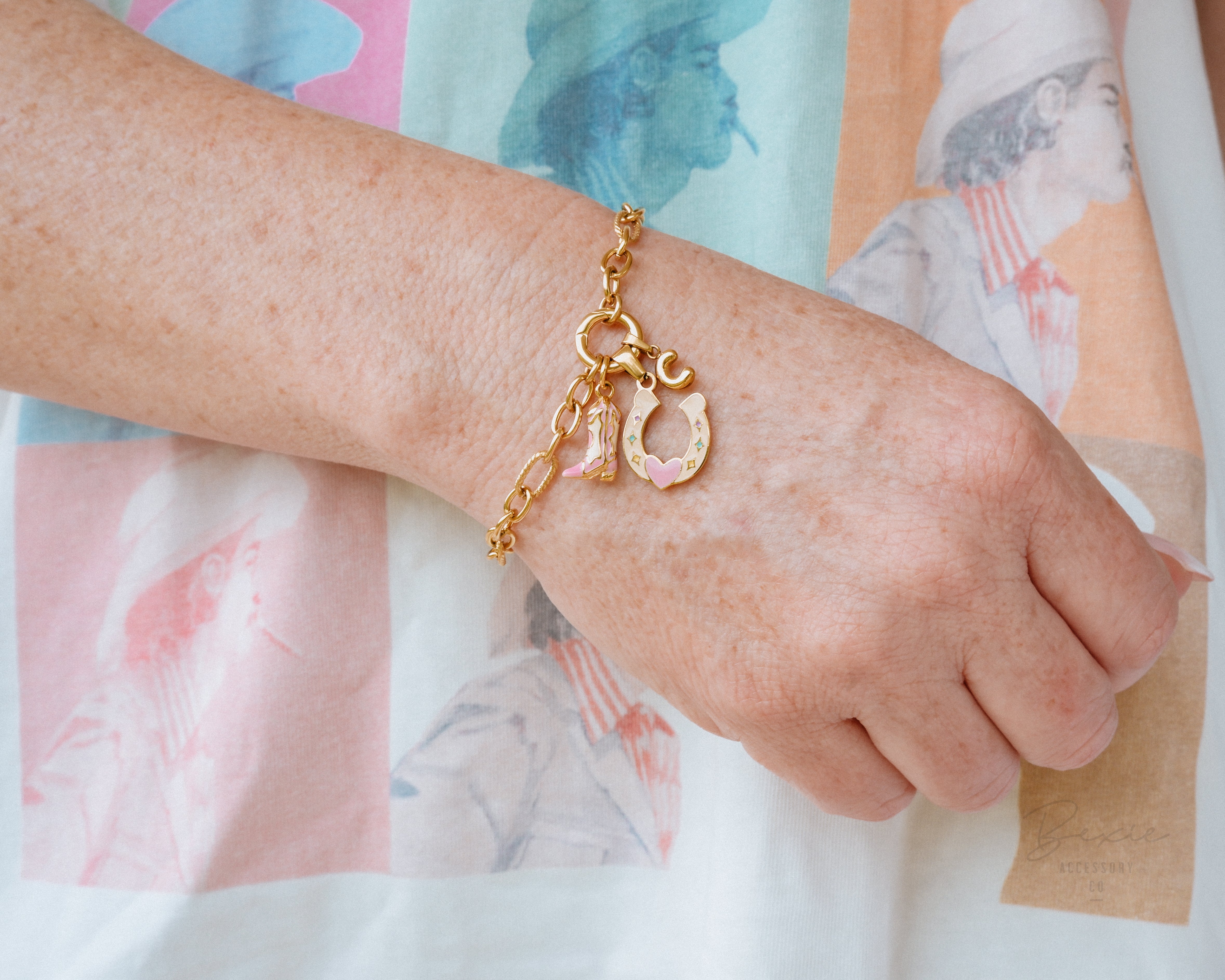 Colourful Cowgirl Boot, Horseshoe & initial charms on a gold western charm bracelet being worn | Affordable waterproof tarnish proof personalised surgical steel jewellery Australia Beach Gym Swim