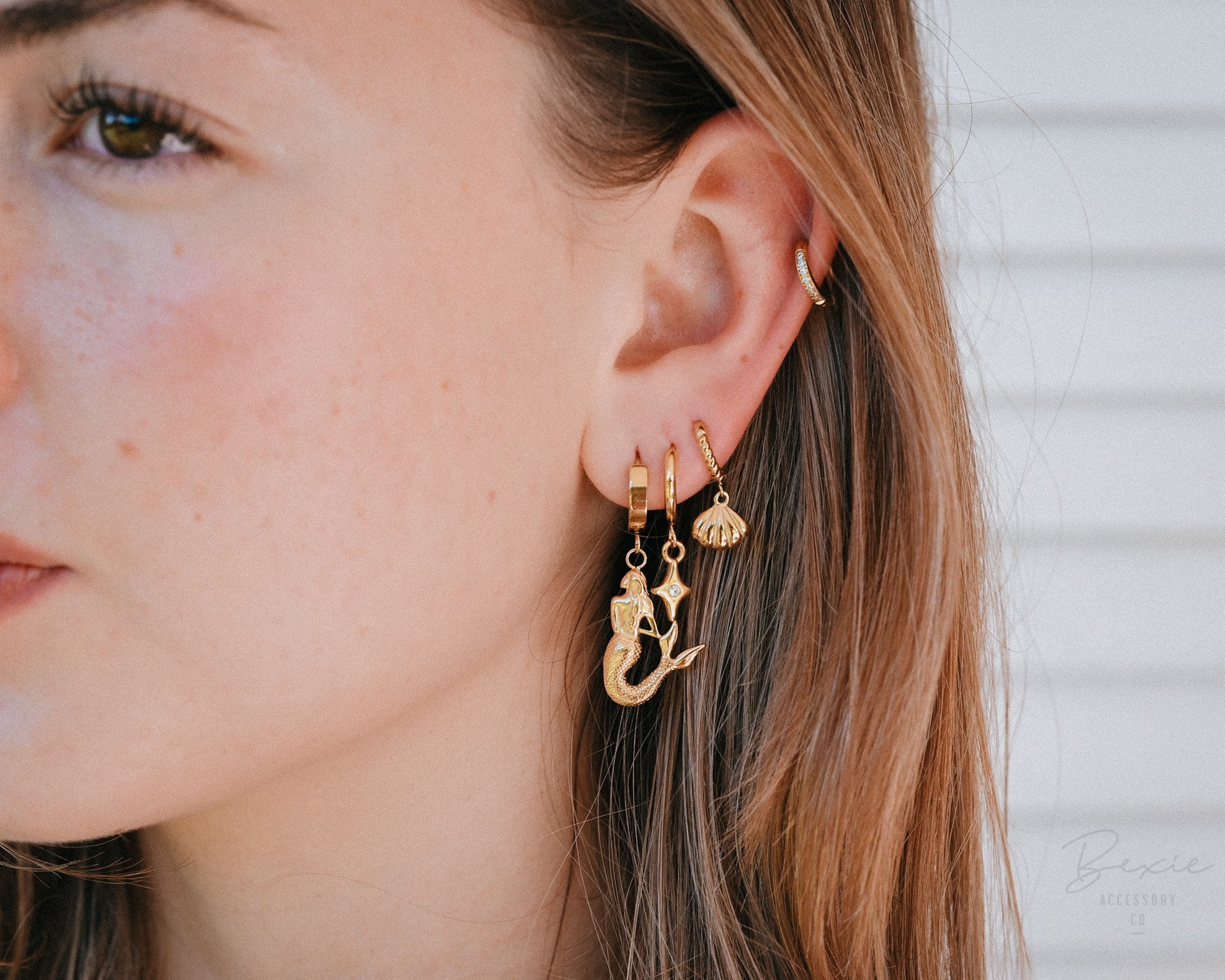 Gold mermaid, star and shell earrings modelled | Australia's best selling affordable, waterproof, tarnish proof surgical steel jewellery